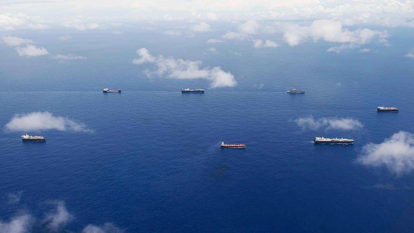 Various US Navy at-sea-replenishment and sealift ships sail in formation. <em>USN</em>