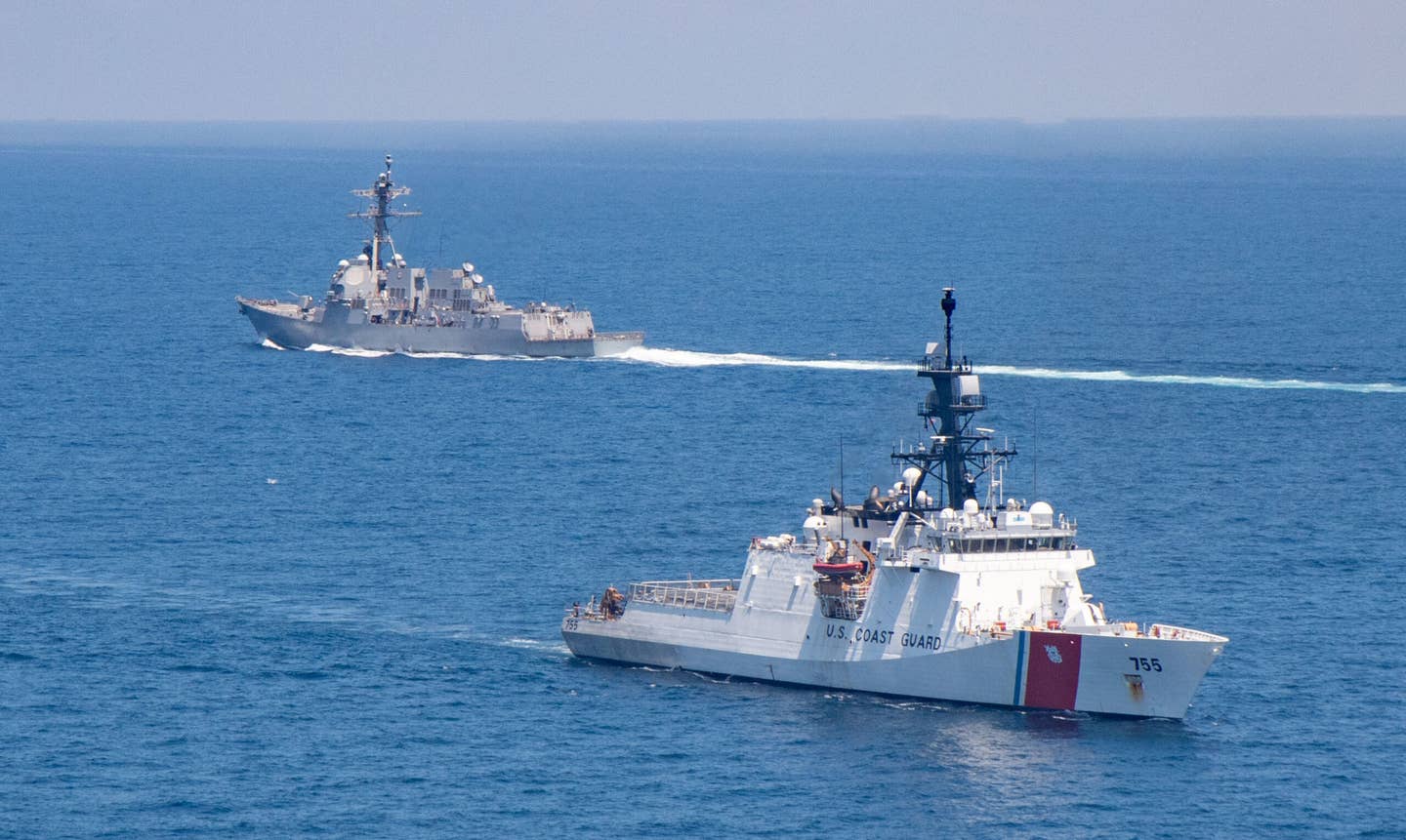 The US Coast Guard's <em>Legend</em> class National Security Cutter USCGC<em> Munro</em>, in the foreground, and the US Navy's <em>Arleigh Burke</em> class destroyer USS <em>Kidd</em>, in the background, in the Taiwan Strait in 2021. U.S. warships sail through this waterway, which Chinese authorities claim as their sovereign territory, with some regularity as part of so-called Freedom of Navigation patrols, or FONOPs. <em>USN</em>