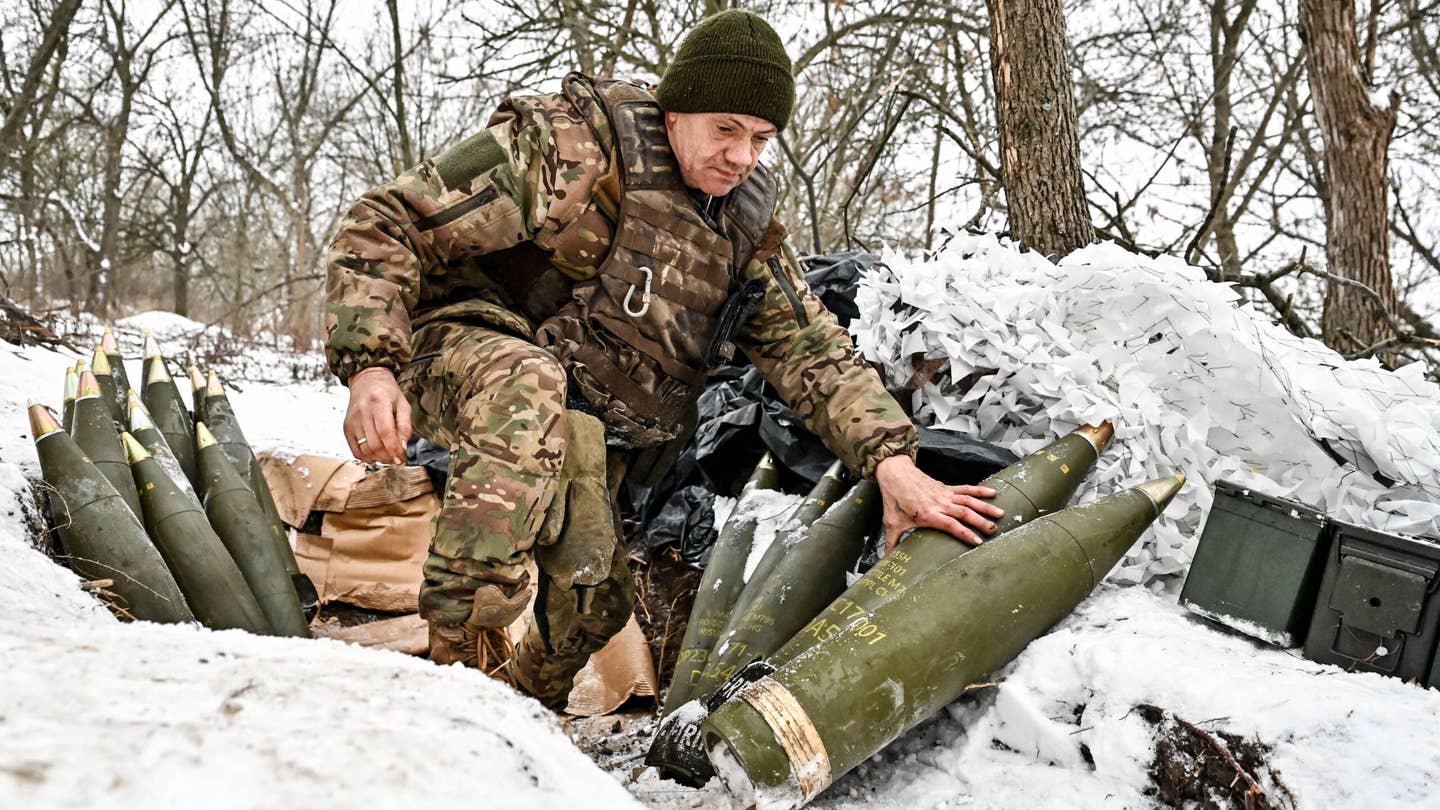 ZAPORIZHZHIA DIRECTION, UKRAINE - JANUARY 14, 2024 - A serviceman of the 66th separate cannon artillery battalion of the 406th separate artillery brigade of the Armed Forces of Ukraine is pictured by the howitzer shells, Zaporizhzhia direction, south-eastern Ukraine.
