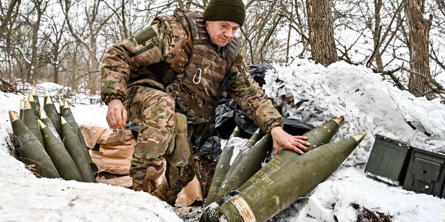 ZAPORIZHZHIA DIRECTION, UKRAINE - JANUARY 14, 2024 - A serviceman of the 66th separate cannon artillery battalion of the 406th separate artillery brigade of the Armed Forces of Ukraine is pictured by the howitzer shells, Zaporizhzhia direction, south-eastern Ukraine.