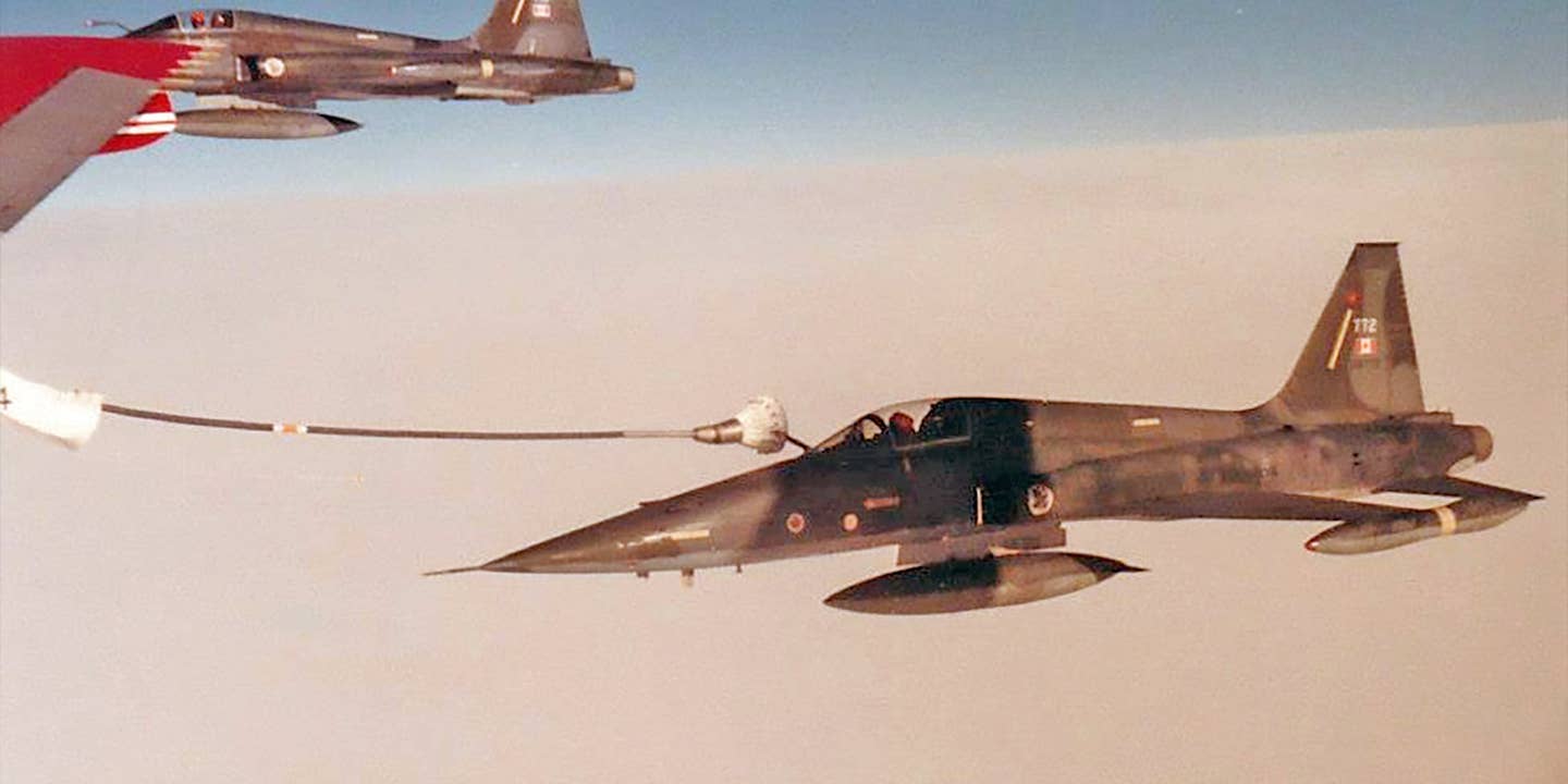 CF-5 refuels from a 707 tanker.
