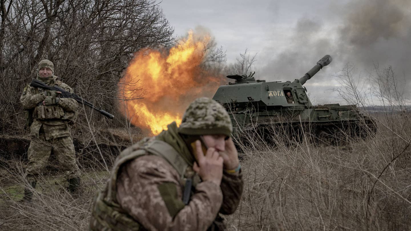 DONETSK OBLAST, UKRAINE - DECEMBER 28: A Ukrainian soldier fires towards the Russian position as the Ukrainian soldiers from the artillery unit wait for ammunition assistance at the frontline in the direction of Avdiivka as the Russia-Ukraine war continues in Donetsk