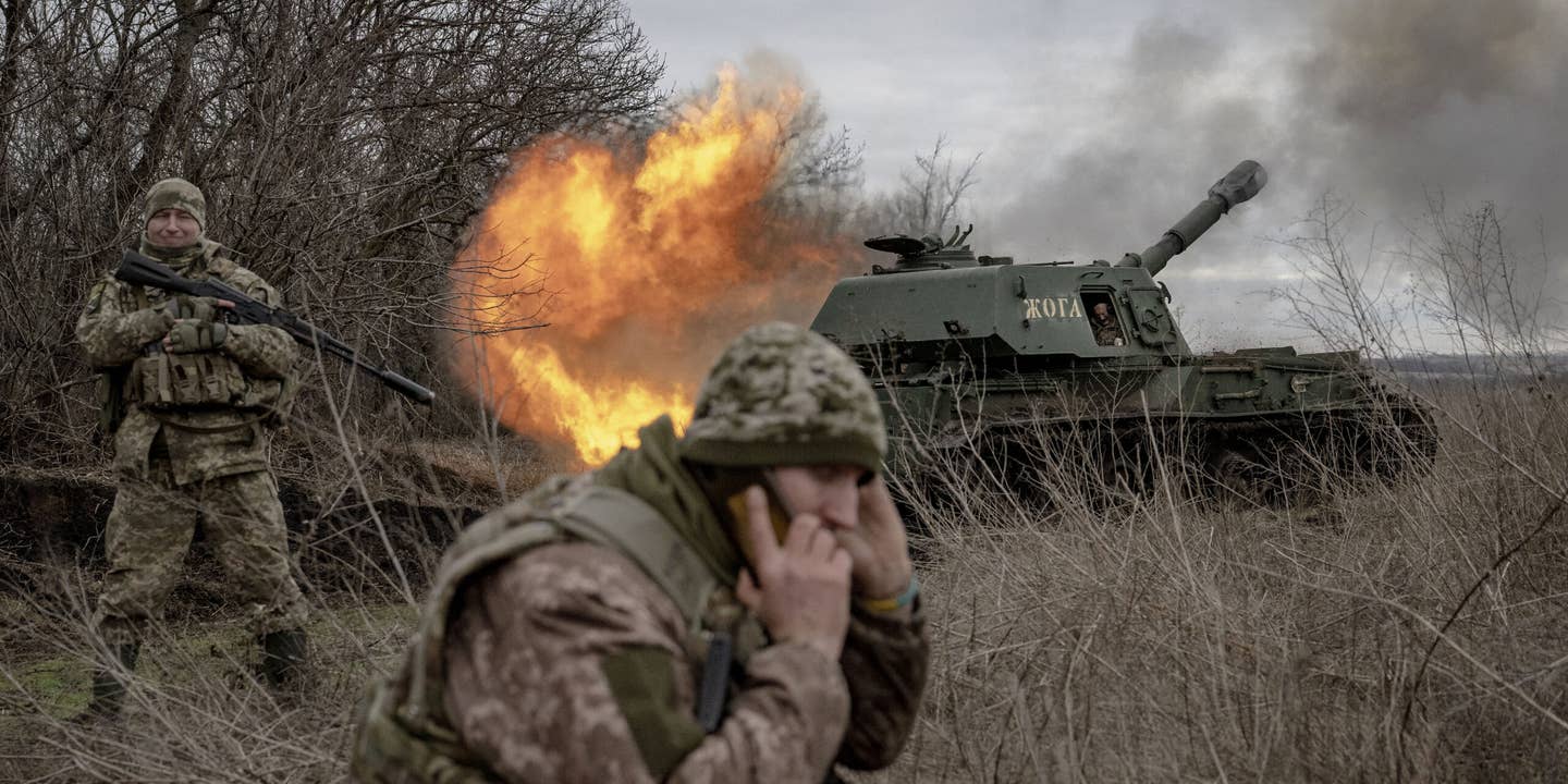 DONETSK OBLAST, UKRAINE - DECEMBER 28: A Ukrainian soldier fires towards the Russian position as the Ukrainian soldiers from the artillery unit wait for ammunition assistance at the frontline in the direction of Avdiivka as the Russia-Ukraine war continues in Donetsk
