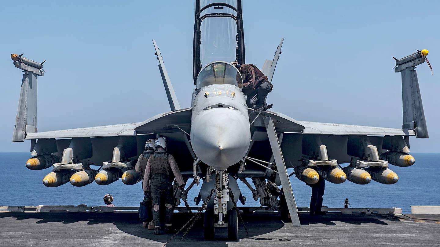 A US Navy F/A-18F Super Hornet with 10 1,000-pound-class GBU-32/B Joint Direct Attack Munition (JDAM) precision-guided bombs. This picture gives a good sense of the Super Hornet's payload capacity and how those jets would be able to take advantage of a cruise missile with a lighter weight and smaller form factor than more traditional designs. <em>USN</em>