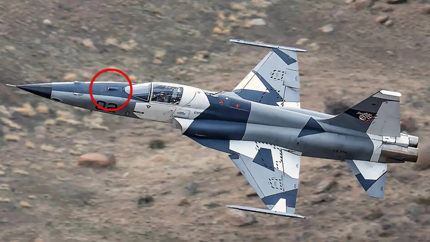 A TacAir F-5AT aggressor jet with the TacIRST system installed. The sensor is seen highlighted inside the red circle on the aircraft's nose. <em>TacAir</em>