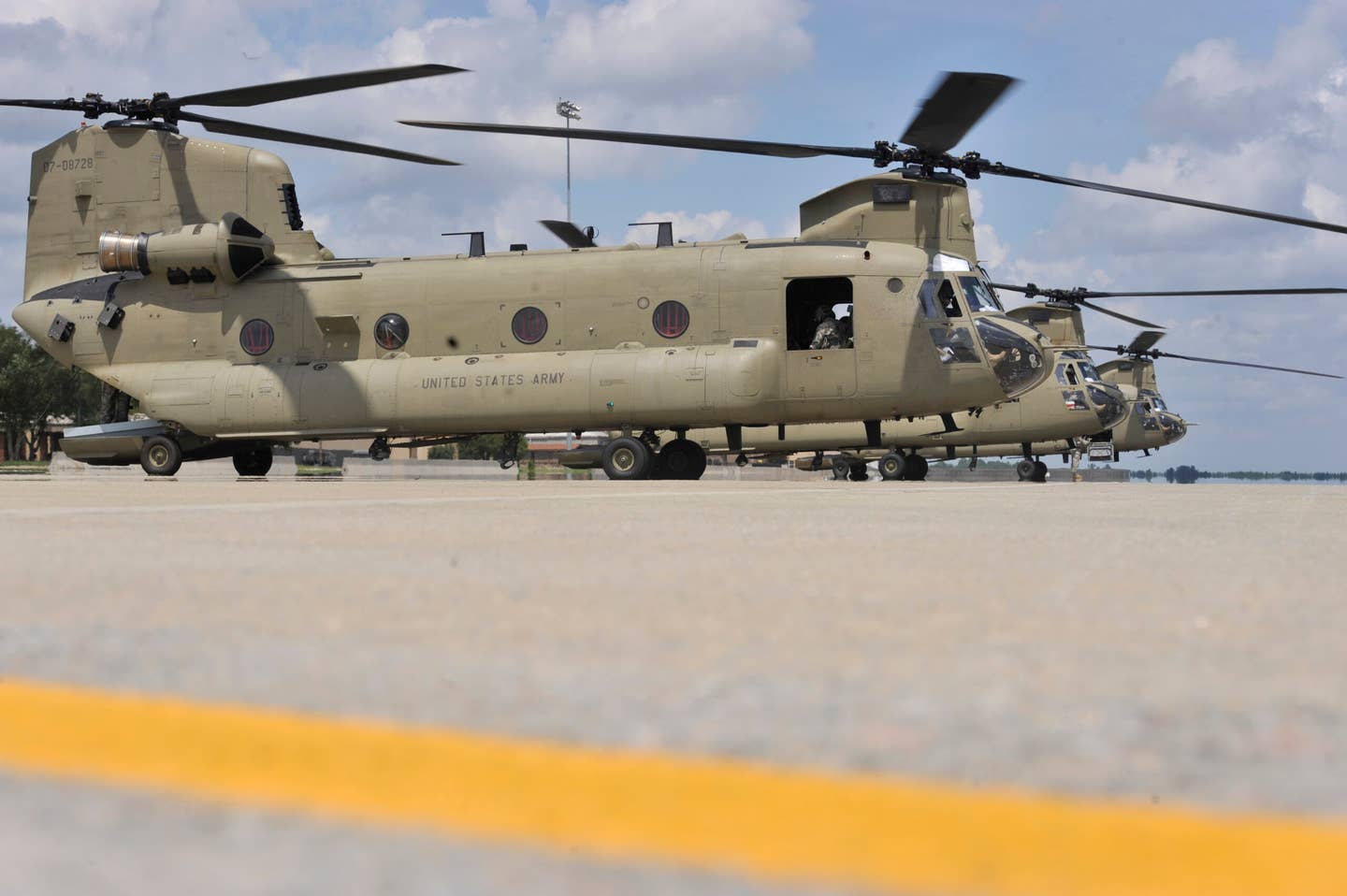 Three U.S. Army CH-47F sit on the flight line waiting to depart from Shaw Air Force Base, South Carolina, August 9, 2013. <em>U.S. Air Force photo by Airman 1st Class Jonathan Bass/Released</em>