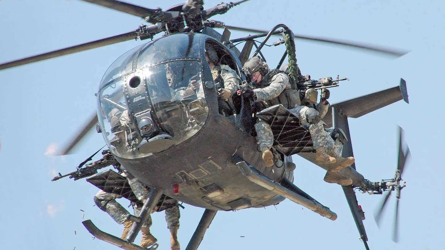 An MH-6 Little Bird laden with special operators. AH-6s are instead configured as light attack helicopters. SOCOM
