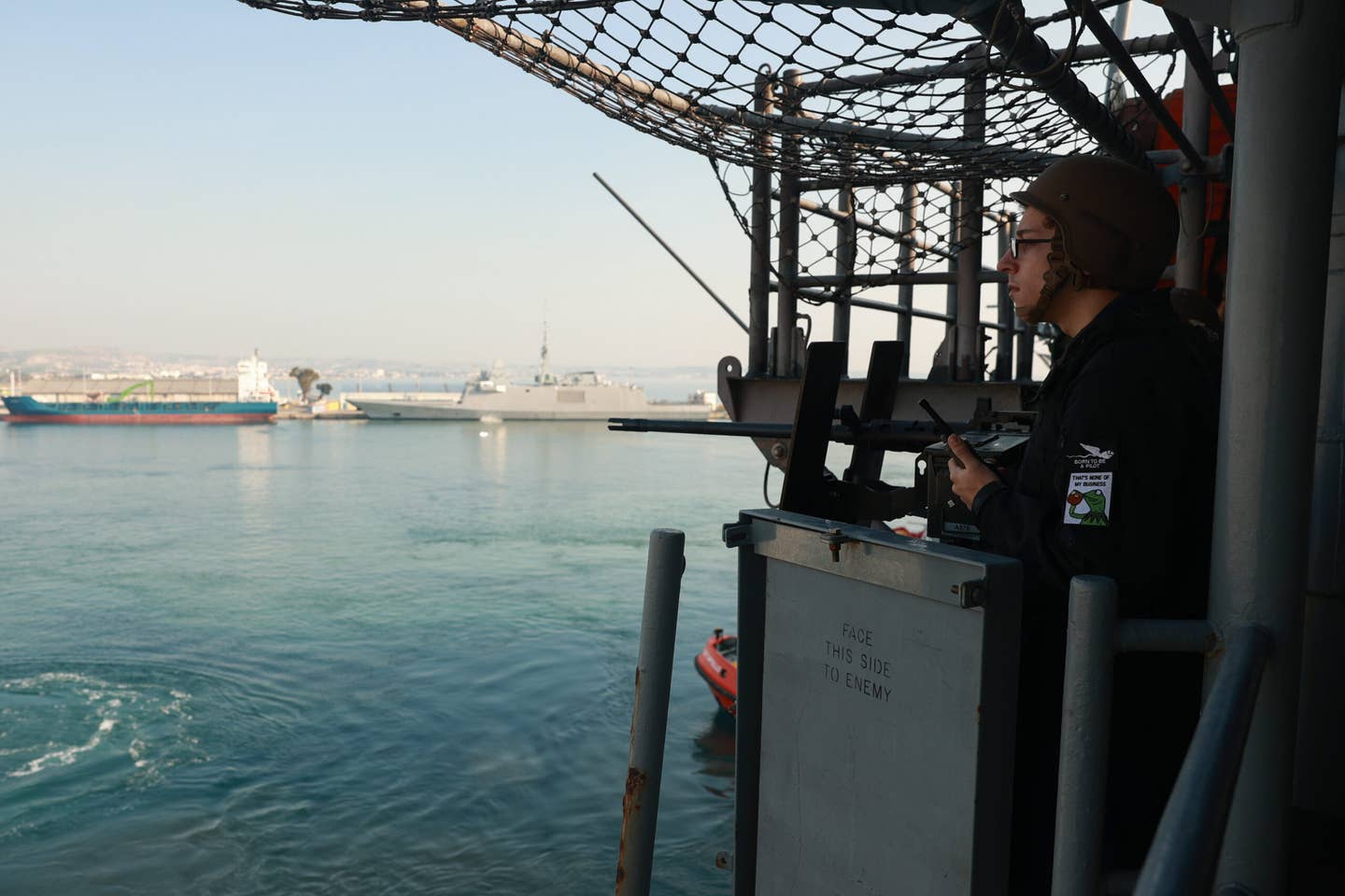 An aviation ordnanceman assigned to the USS <em>Bataan</em> stands small caliber arms team watch while the warship pulls into Larnaca, Cyprus, on February 11, 2024. <em>U.S. Navy photo by Mass Communication Specialist 2nd Class Riley Gasdia</em>