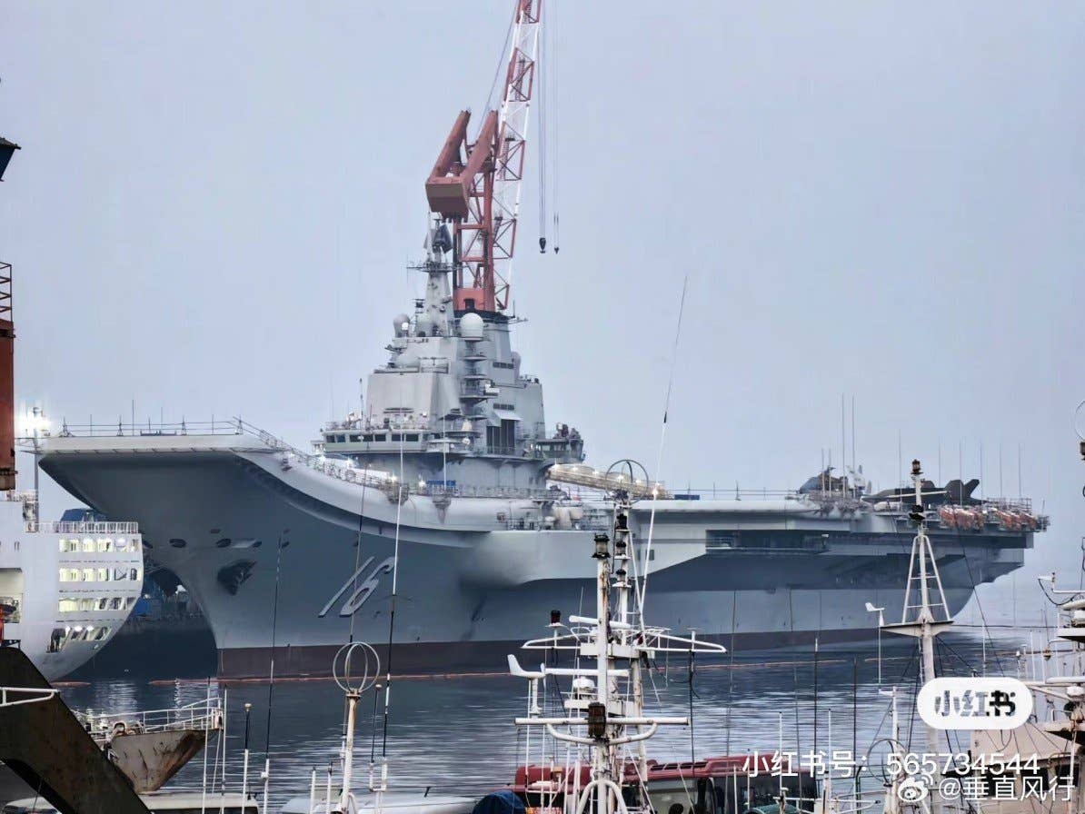 Wrapped in a dark tarpaulin, the mockup of the J-35 is visible parked at the end of the deck of the <em>Liaoning</em>. <em>Chinese Internet via X</em>