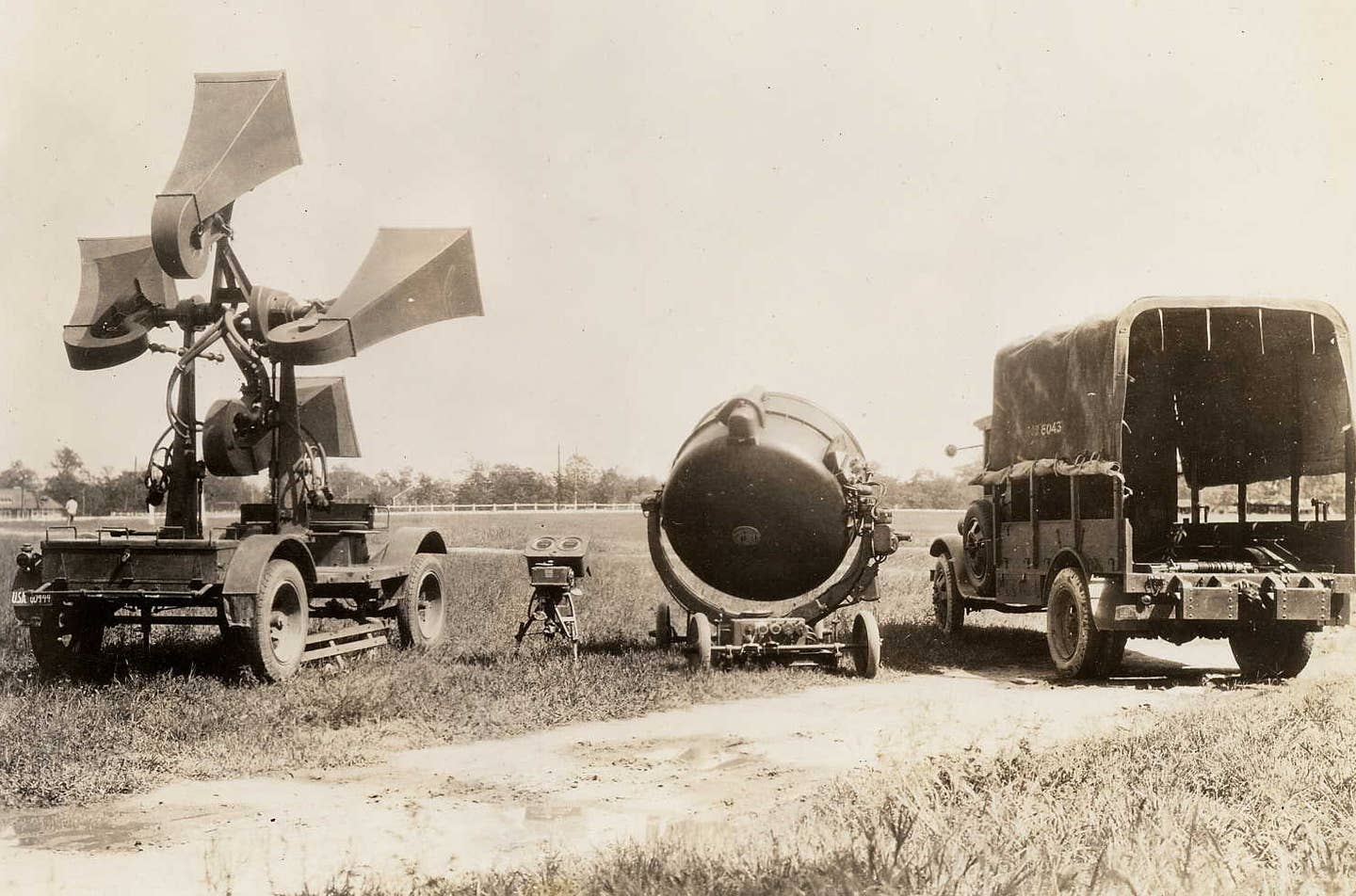 A U.S. Coast Artillery Corps aircraft sound locator system, at left, as well as a searchlight and transport truck, somewhere in the United States in 1932. <em>U.S. Coast Artillery Corps</em>