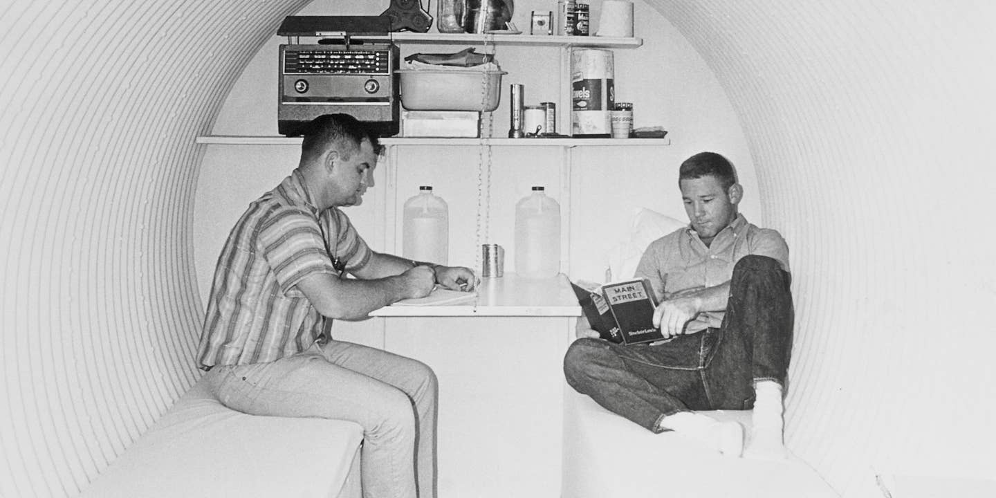 Study in Survival. Lake Charles, Louisiana: Leading a sheltered life at Lake Charles, Louisiana, McNeese State College students, Kelly B. McRight (left) and Dan R. Sistrunk, are deep in a survival test. They spent three days inside this fallout shelter in an experiment conducted by the college and civil defense officials. October 9, 1961. Bettmann via Getty Images.