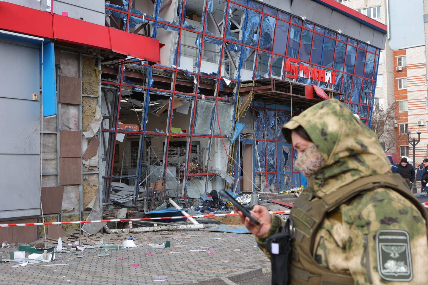 Specialists of various services work by a damaged shopping center following an attack on Belgorod on February 15, 2024. <em>Photo by STRINGER/AFP via Getty Images</em>