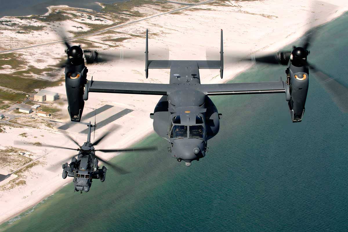 A CV-22 flies alongside an MH-53M Pave Low IV, the aircraft the Osprey replaced within AFSOC. (USAF)