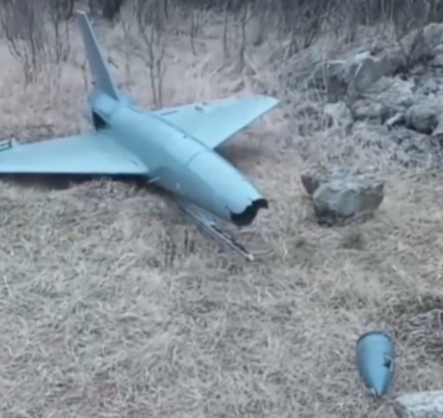 A screen capture from the video shows what appears to be the warhead, closest to the camera, as well as a distinctive rail under the body of the drone. <em>via X</em>