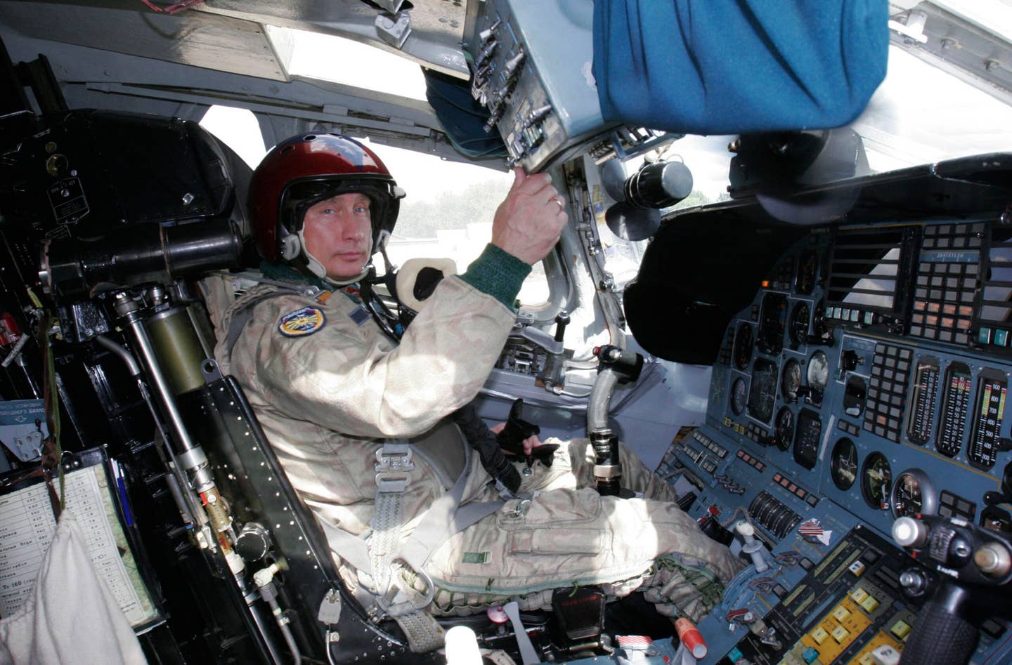 A photo taken on August 16, 2005, shows Vladimir Putin in the cockpit of a Tu-160 at a military airport, outside Moscow, before his supersonic flight in the bomber. <em>VLADIMIR RODIONOV/AFP via Getty Images</em>