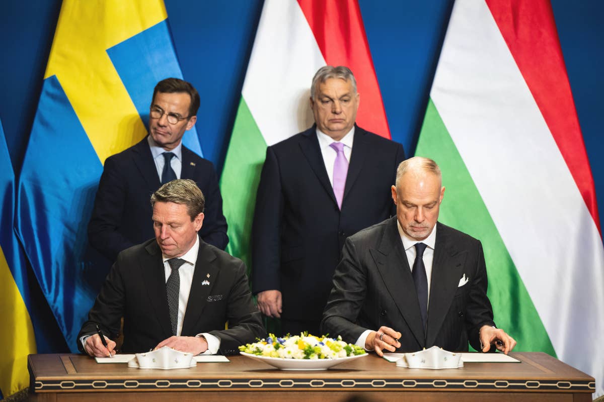 Goran Martensson, director general of the Swedish Defense Materiel Administration, seated at left, and Hungarian Defense Minister Kristof Szalay-Bobrovniczky, to his right, sign the Gripen contract in Budapest today. Swedish and Hungarian Prime Ministers Ulf Kristersson, left, and Viktor Orban, right, are seen standing. <em>Marton Monus/picture alliance via Getty Images</em>