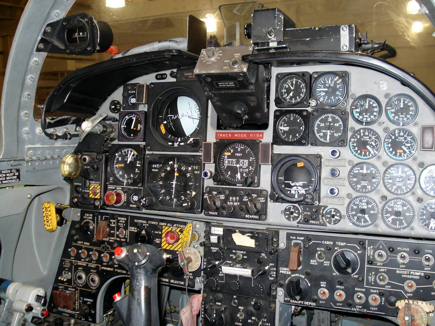 Cockpit of the CF-5A. The main attitude indicator is the grey and black one at top, and the standby is the featureless black ball to the right of the altimeter (a J-8 model). <em>Dan McWilliams</em>