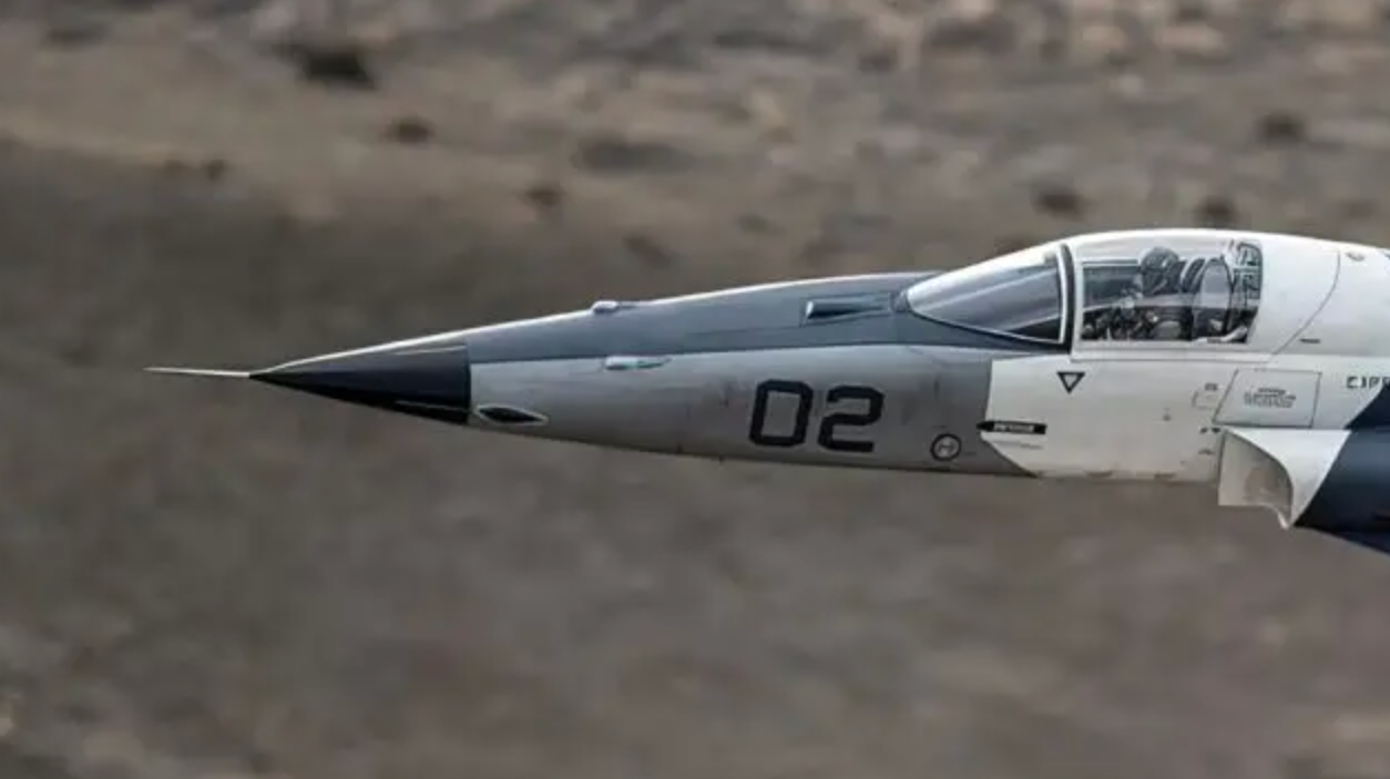 A zoomed-in shot of an F-5AT during flight testing with its IRST. The forward-staring device can be seen directly in front of the cockpit windscreen.&nbsp;<em>TacAir</em>