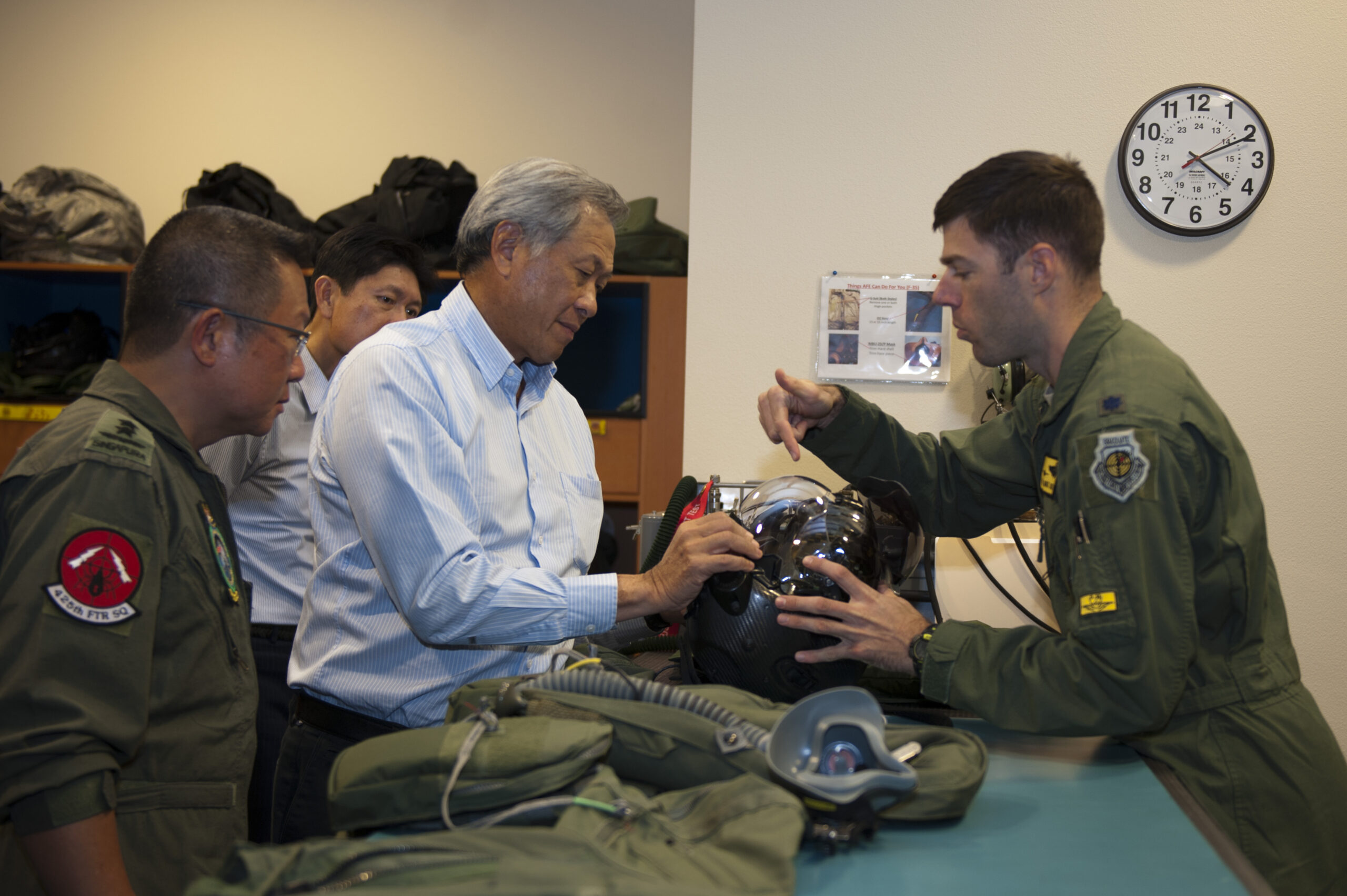 Singaporean Minister of Defense Dr. Ng Eng Hen learns about the F-35 helmet-mounted display system during a visit to the 61st Fighter Squadron at Luke Air Force Base, Arizona, December 10, 2015. <em>U.S. Air Force photo by Staff Sgt. Staci Miller</em><br><a href="https://www.luke.af.mil/News/Article-Display/Article/640795/rsaf-hone-combat-skills-during-forging-sabre-exercise/undefined"></a>