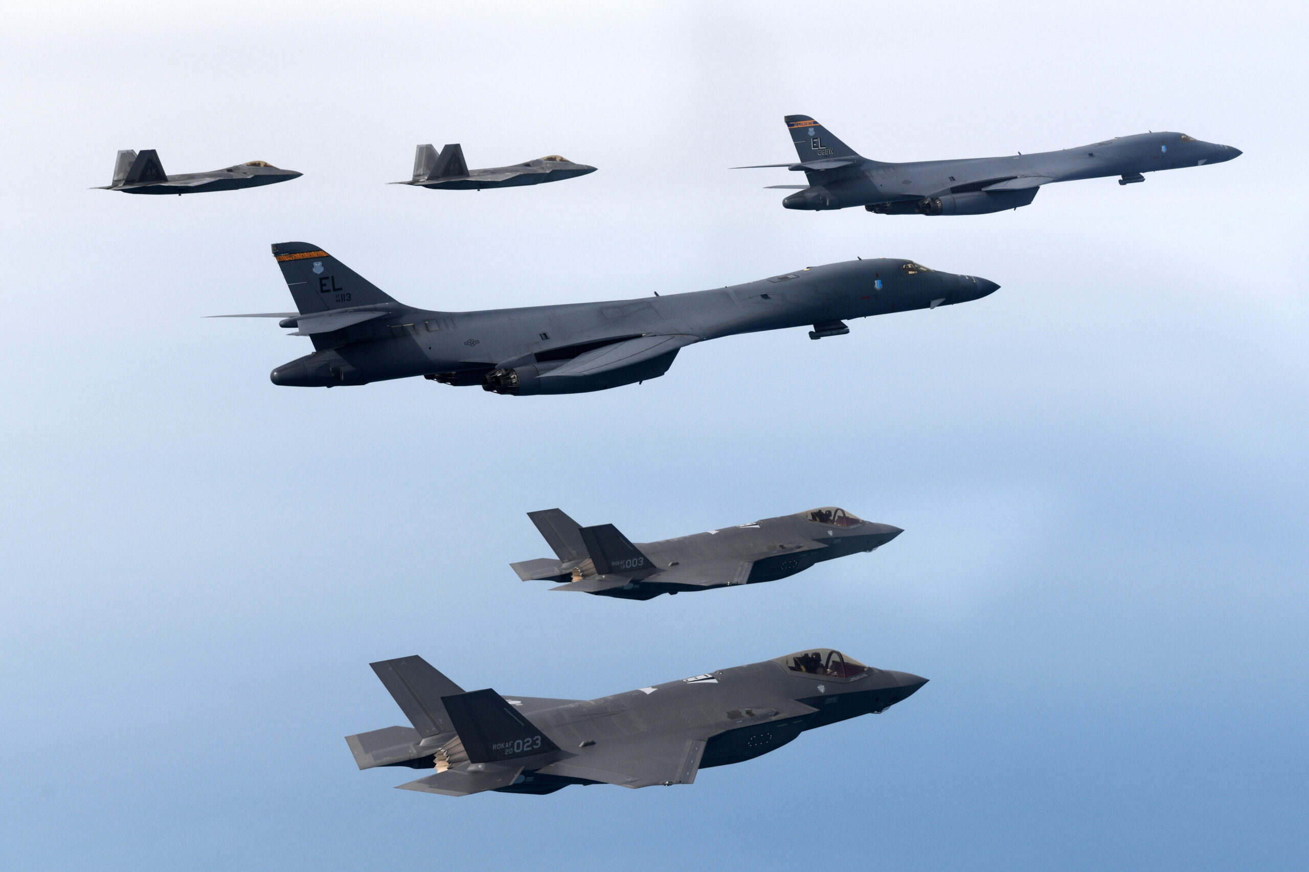 A U.S. Air Force B-1B bomber and F-22 stealth fighters together with Republic of Korea Air Force F-35As fly over South Korea during a joint air drill on February 1, 2023. <em>Photo by South Korean Defense Ministry via Getty Images</em>
