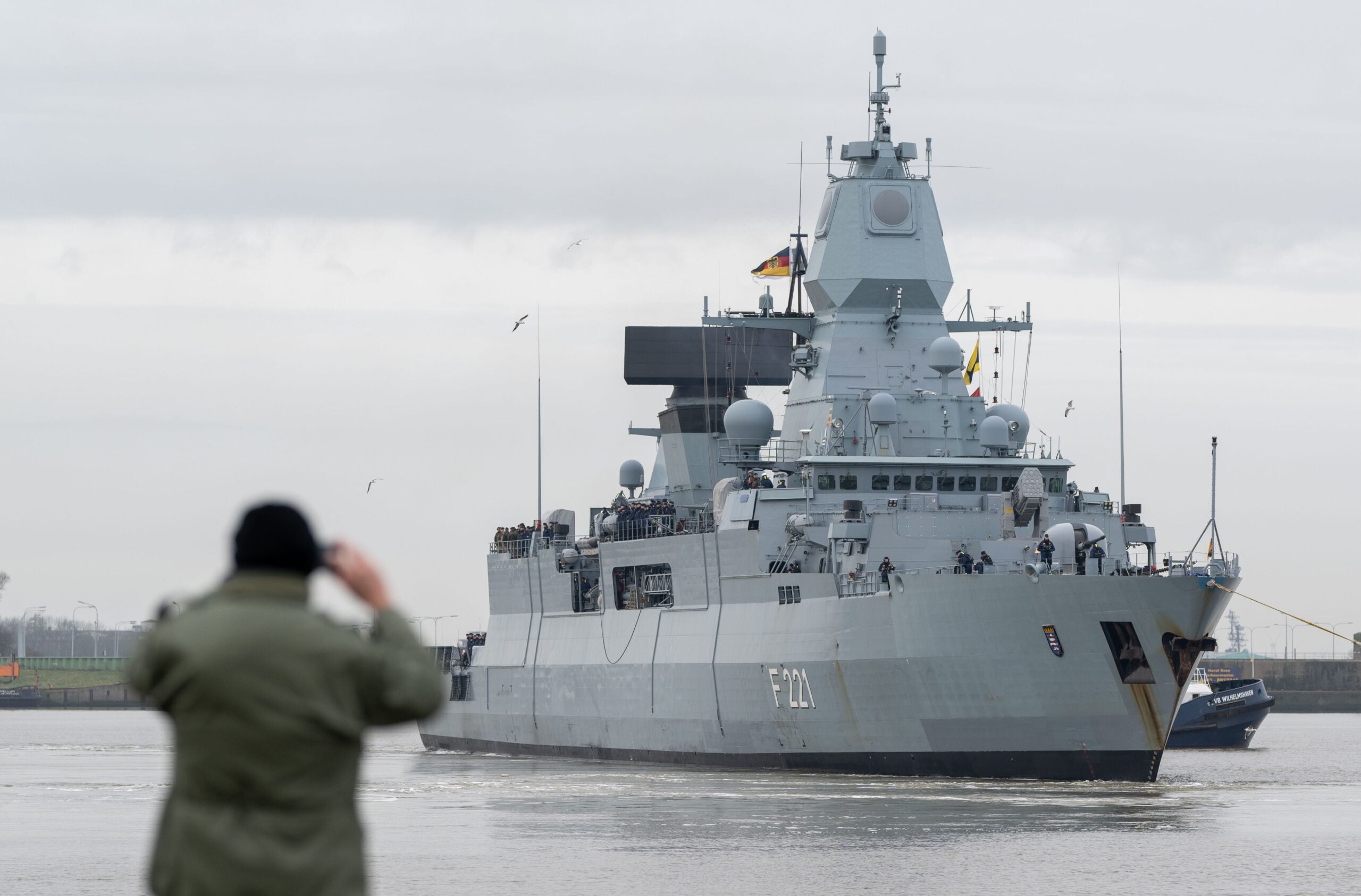 WILHELMSHAVEN, GERMANY - FEBRUARY 8:  A family member of the German Navy frigate "Hessen" take pictures during the depart for deployment in the Red Sea on February 8, 2024 in Wilhelmshaven, Germany. The F124 type "Hessen," with its total crew of approximately 240, will join the international EUNAVFOR ASPIDES force seeking to protect commercial vessels from attack by Houthi rebels. (Photo by David Hecker/Getty Images)