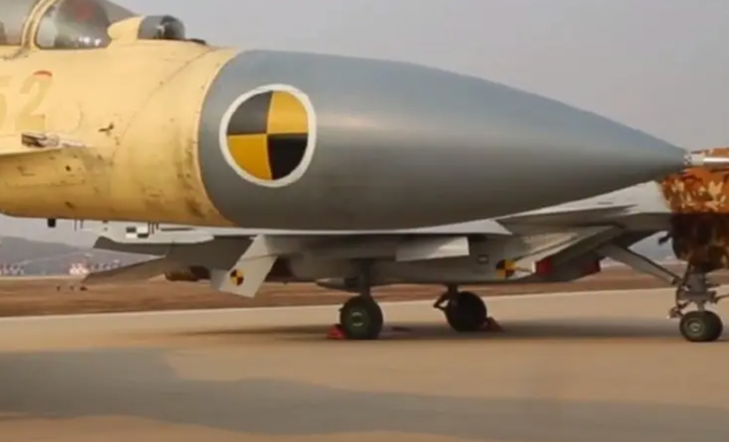 A rare view of a CATOBAR-capable J-15. The J-15T version (seen in the background) has a revised nose landing gear featuring a catapult launch bar.&nbsp;<em>Chinese TV screencap</em>