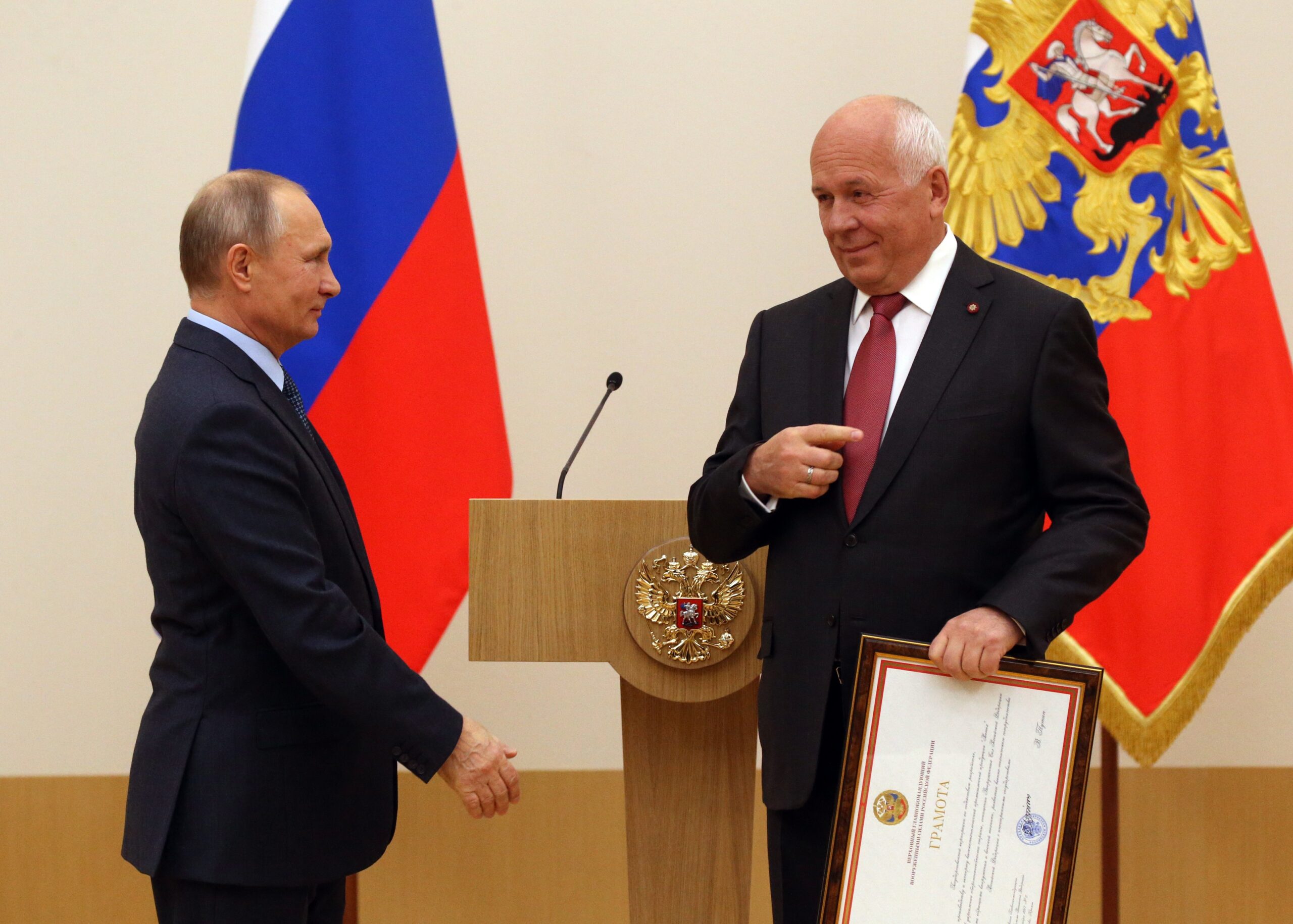 NOVO OGARYOVO, RUSSIA - DECEMBER, 7: (RUSSIA OUT)  Russian President Vladimir Putin (L) greets CEO of Rostec Corporation Sergey Chemezov during the reception on Rostec State Corporation's 10-th anniversary at Novo Ograyovo State Residence, outskirts of Moscow, Russia, December 7, 2017. Putin confirmed that the will run the Presidential Elections 2018 during the meeting with workers of the GAZ plant yesterday. Photo by Mikhail Svetlov/Getty Images)