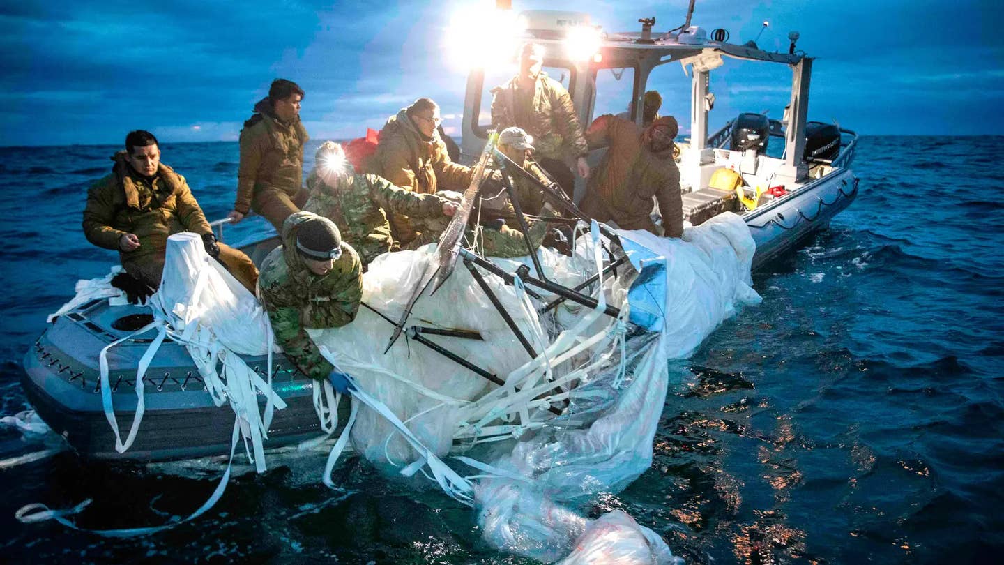 US Navy personnel retrieve a portion of the Chinese spy balloon shot down off the coast of South Carolina in February 2023. <em>USN</em>