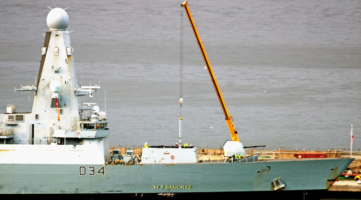 A crane is used to reload the vertical launch cells on HMS <em>Diamond</em> in Gibraltar last month. <em>Michael J Sanchez/@key2med</em>