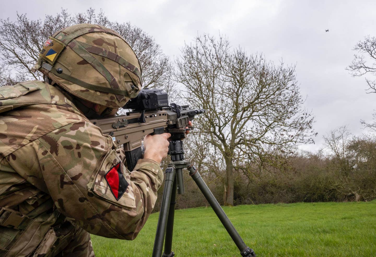 A member of the 16th Air Assault Brigade Combat Team takes aim at a small drone with an L85A3 rifle with a SMASH X4 sighting system during training. <em>Crown Copyright</em>