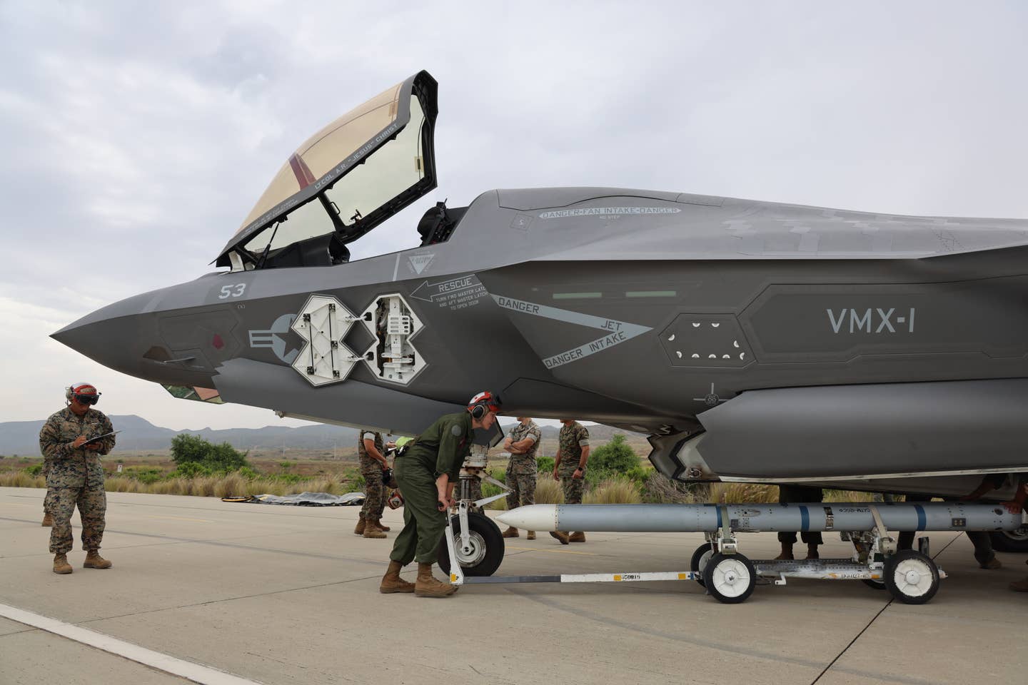 Marines load AIM-120 captive training rounds onto a VMX-1 F-35B at an austere forward base during training. (Author's photo)