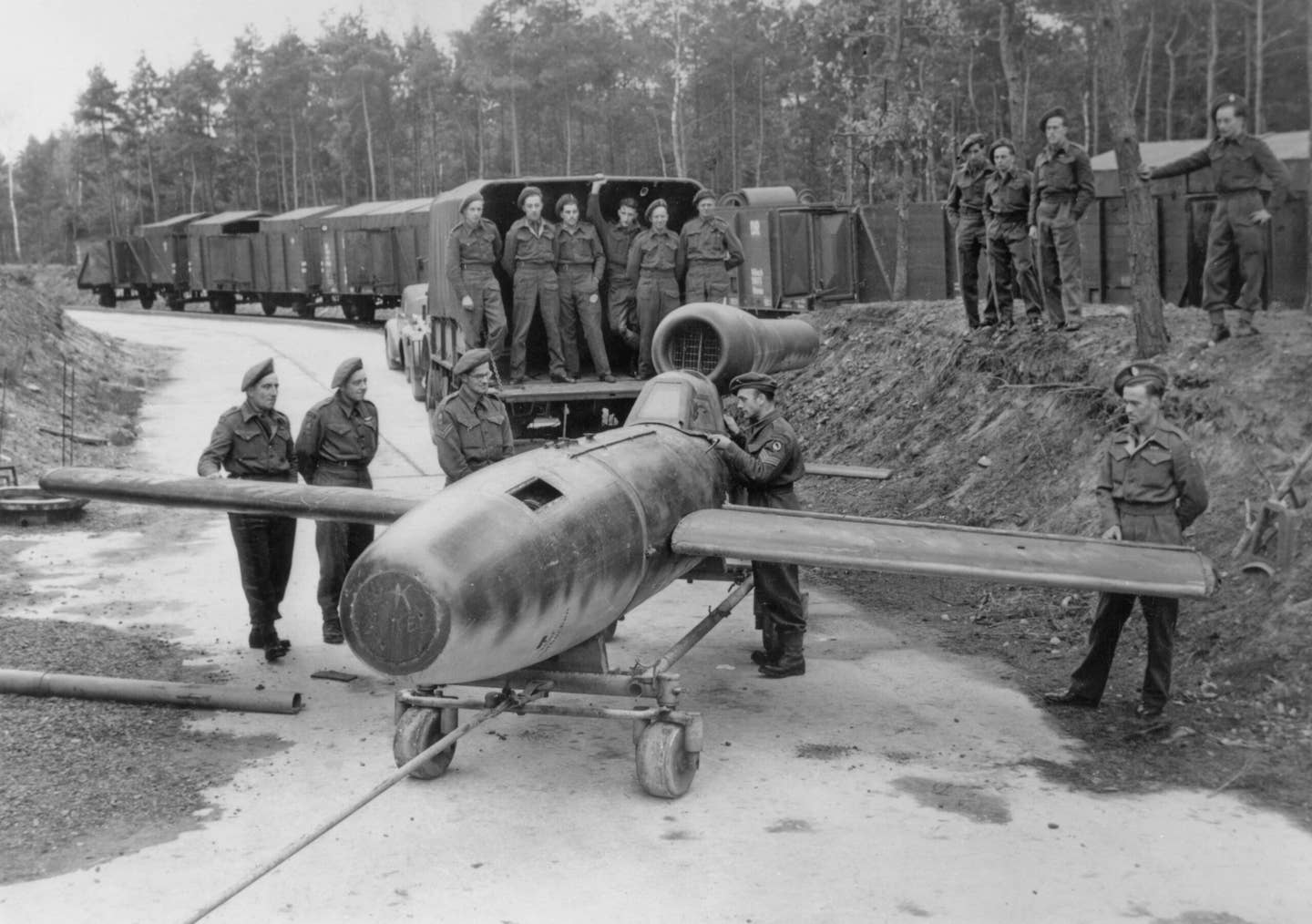 British Army soldiers examine a captured pulsejet-engined Fieseler Fi 103R Reichenberg — a piloted version of the V-1 flying bomb — in Lower Saxony, Germany, in November 1945. <em>Photo by Chris Ware/Keystone/Hulton Archive/Getty Images</em>