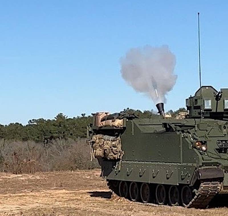 A low-quality image showing an M1287 AMPV mortar carrier vehicle being fired during an exercise. <em>U.S. Army</em>