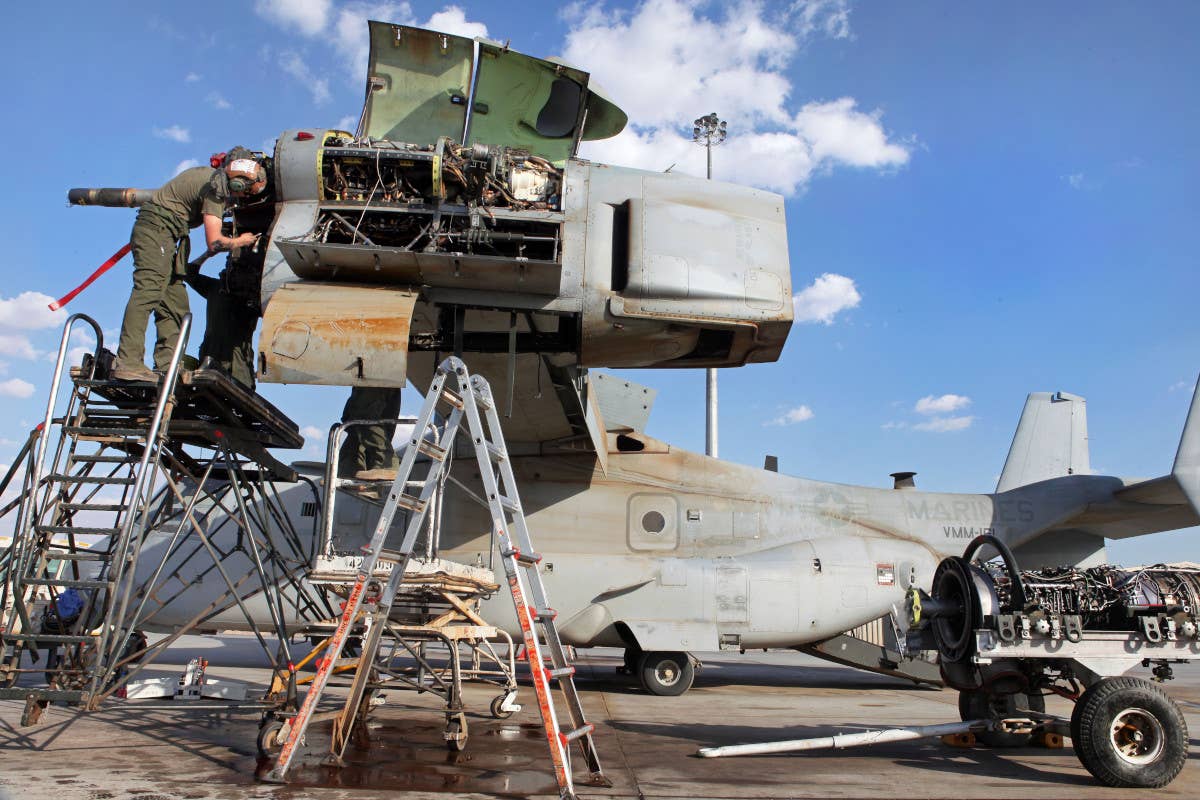 A Marine conducts engine maintenance on an MV-22B Osprey. <em>DOD</em>
