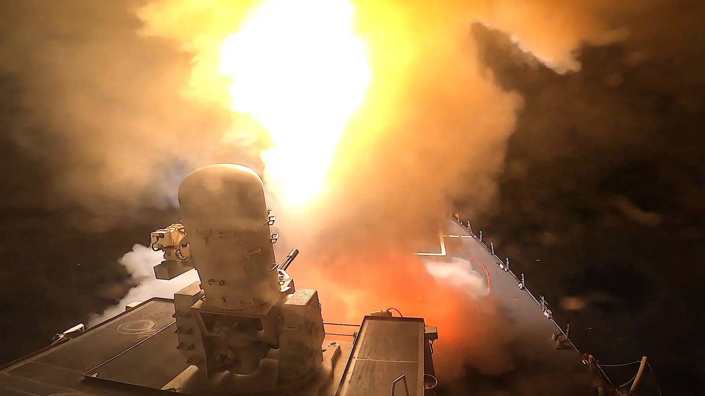 The U.S. Navy's <em>Arleigh Burke</em> class destroyer USS <em>Carney</em> fires a missile at a Houthi threat in October 2023. Also visible in the foreground is a Phalanx CIWS. <em>USN</em>