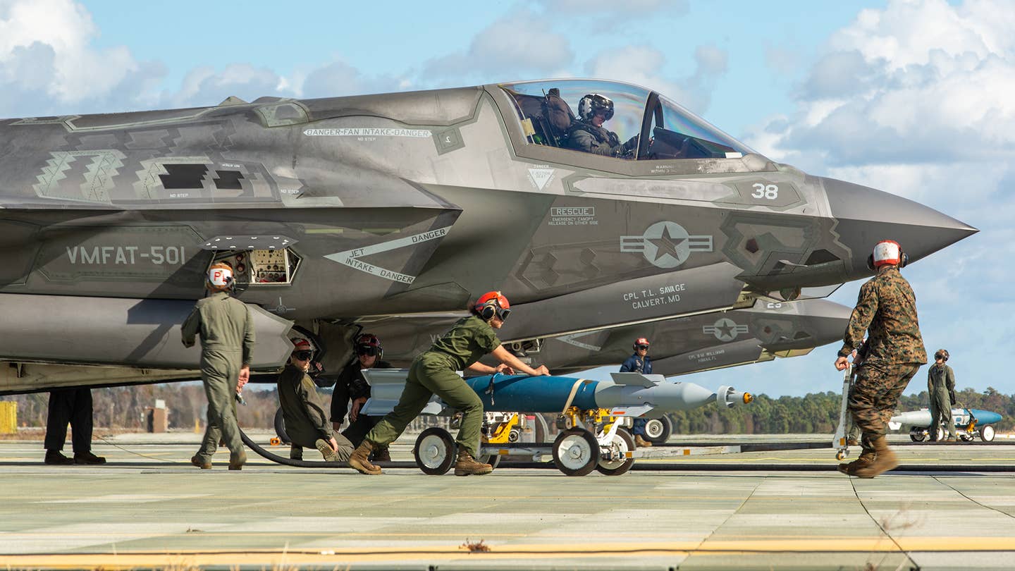F-35Bs are armed on a flight line