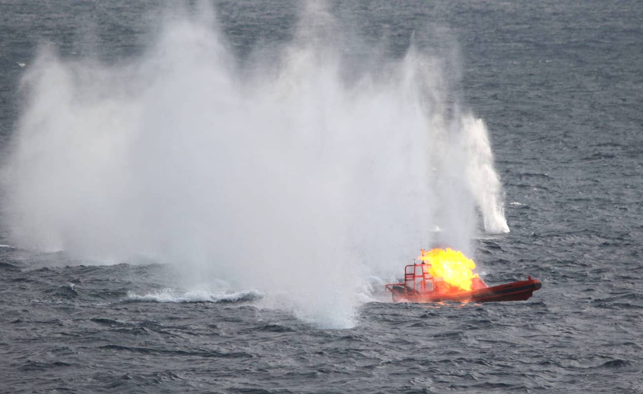 A target boat is seen in flames after being engaged by a Phalanx CIWS onboard the U.S. Navy's <em>Ticonderoga</em> class cruiser USS Antietam during training. <em>USN</em>