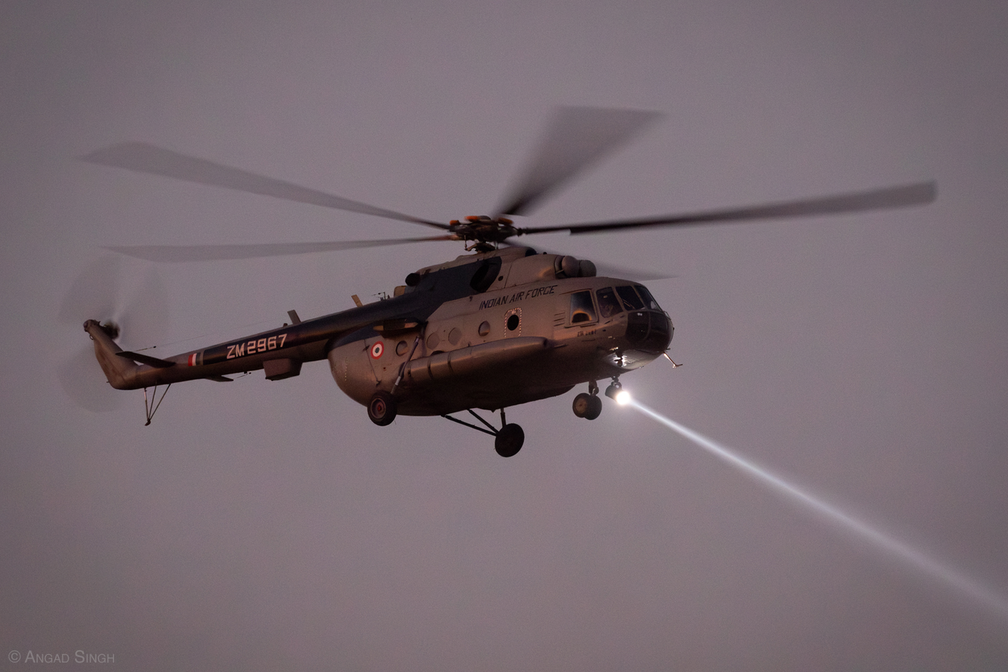A Mil Mi-17 using its searchlight as illumination for a second helicopter inserting special forces. <em>Angad Singh</em>