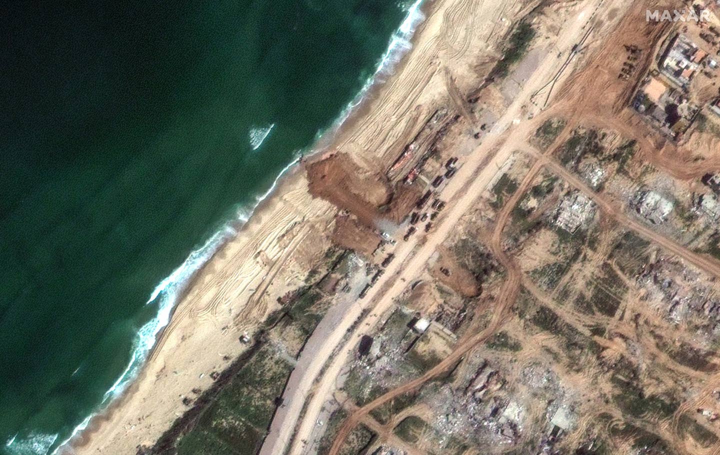 Signs of the early stages of work on the new jetty at the site near Gaza City in a satellite image taken on March 11, 2024. <em>Satellite image ©2024 Maxar Technologies</em>