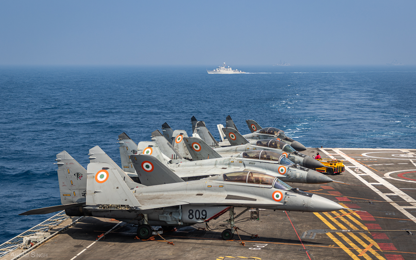 MiG-29Ks parked on the flight deck of INS <em>Vikramaditya</em> as exercise warships steam away toward Visakhapatnam after the conclusion of the sea phase. The nearest vessel is a Vietnam People’s Navy <em>Pohang</em> class corvette. <em>Angad Singh</em>
