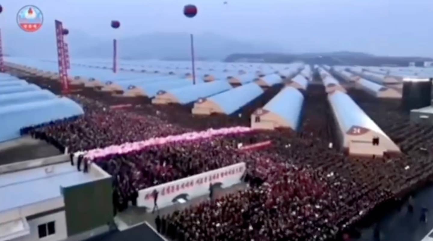 Crowds gather in anticipation of Kim's arrival at the unspecified event. <em>KCNA</em>