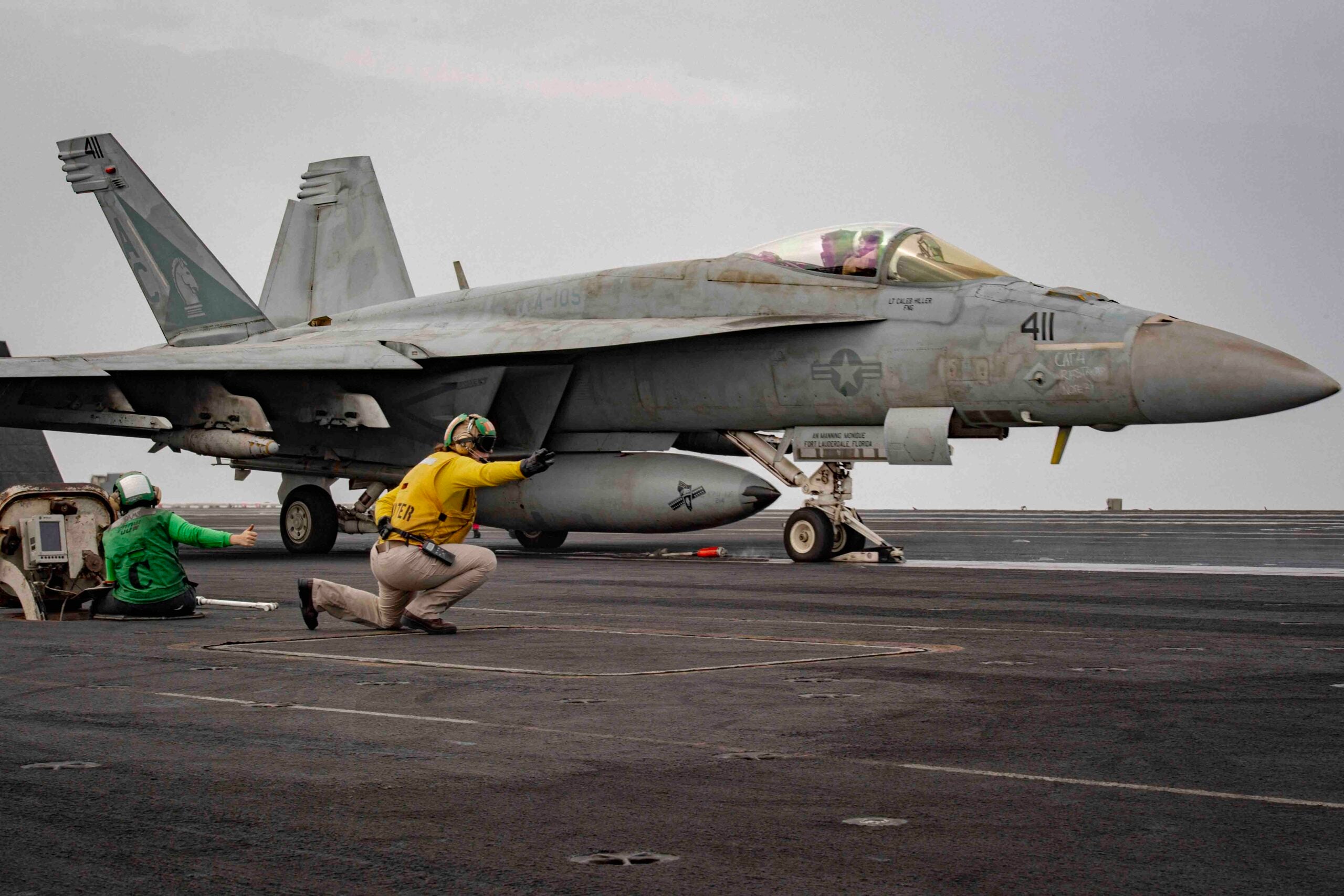 240305-N-DH109-1020 RED SEA (March 5, 2024) Sailors signal the launch of an F/A-18E Super Hornet, attached to the "Gunslingers" of Strike Fighter Squadron (VFA) 105, during flight operations aboard the Nimitz-class aircraft carrier USS Dwight D. Eisenhower (CVN 69) in the Red Sea, March 5. The Dwight D. Eisenhower Carrier Strike Group is deployed to the U.S. 5th Fleet area of operations to support maritime security and stability in the Middle East region. (Official U.S. Navy photo)