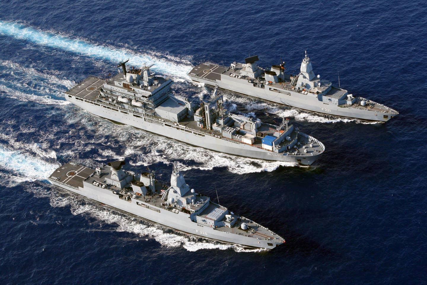 The German Navy frigates <em>Hessen</em> (top) and <em>Hamburg</em> (nearest camera) during replenishment at sea maneuvers with the replenishment ship <em>Berlin</em>. <em>Bundeswehr/Ricarda Schönbrodt</em>
