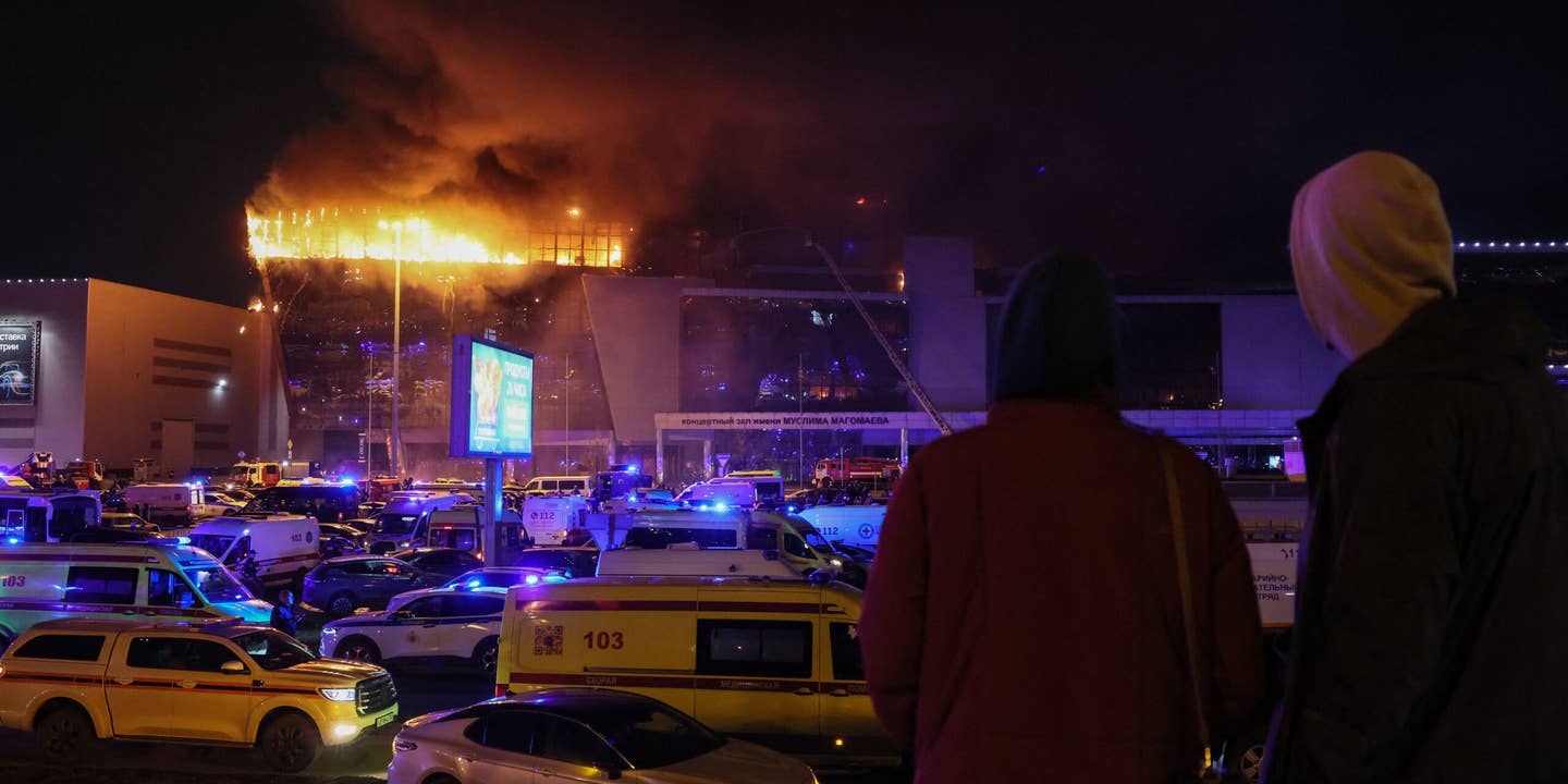Emergency services vehicles are seen outside the burning Crocus City Hall concert hall following the shooting incident in Krasnogorsk, outside Moscow, on March 22, 2024. Gunmen opened fire at a concert hall in a Moscow suburb on March 22, 2024 leaving dead and wounded before a major fire spread through the building, Moscow's mayor and Russian news agencies reported.