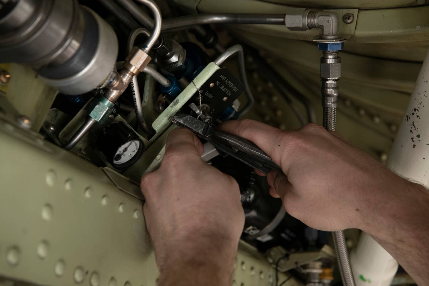 U.S Air Force Staff Sgt. Matthew Sharber, 9th Aircraft Maintenance Squadron U-2 Dragon Lady crew chief, fixes the wiring of TU-2S Dragon Lady 1078 after almost three years of maintenance to restore the two-seater U-2 at Beale Air Force Base, California, January 25, 2024. <em>U.S. Air Force photo by Staff Sgt. Frederick Brown</em>