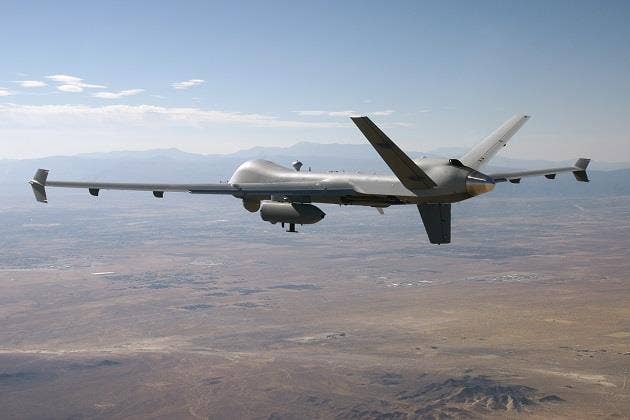 An MQ-9 testing a networking pod over the Mojave Desert. (General Atomics)