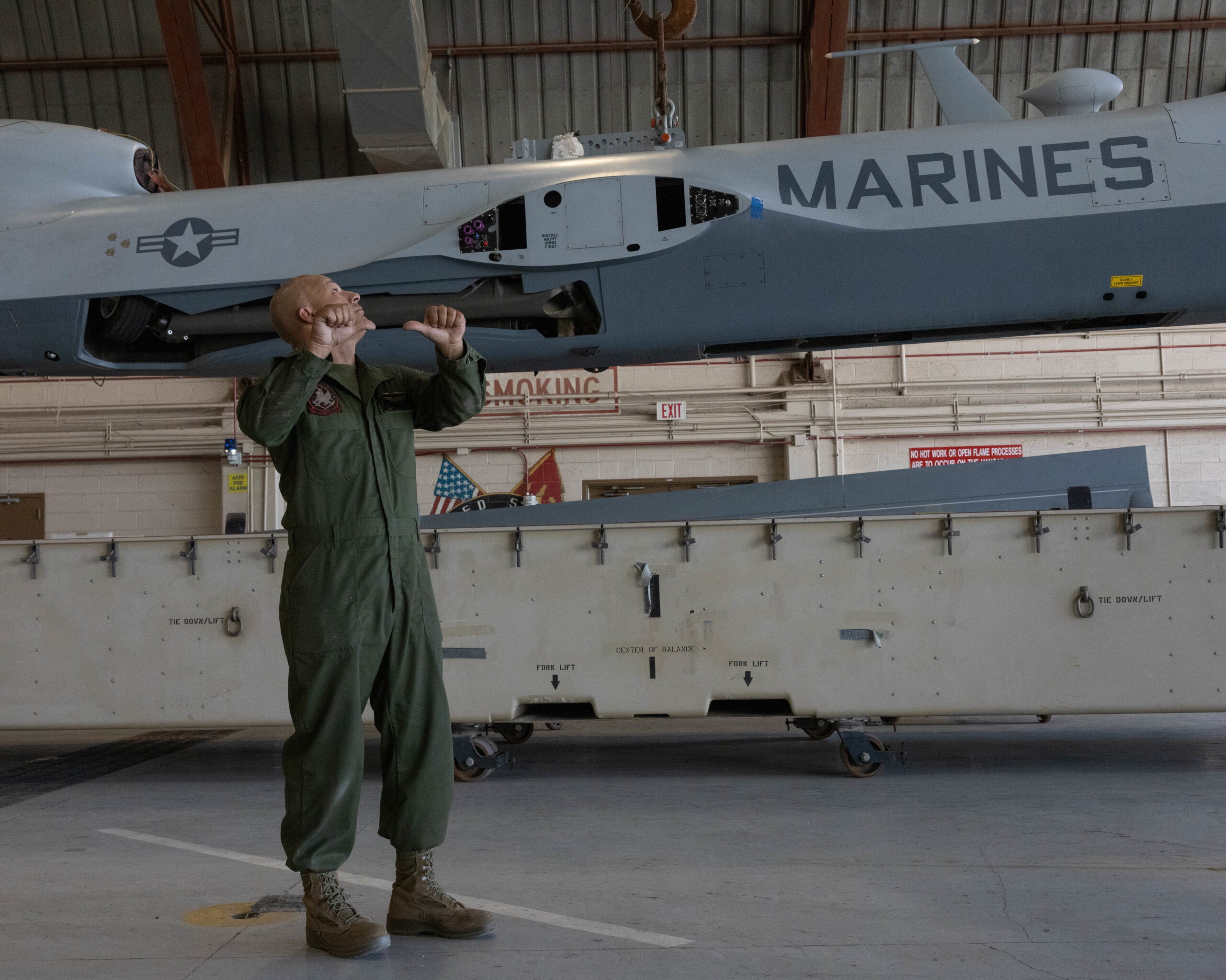 U.S. Marine Corps Staff Sgt. Ricardo Tijerina, airframes staff noncommissioned officer, Marine Operational Test and Evaluation Squadron (VMX) 1, assists in the unloading of the MQ-9A Reaper with Marine Unmanned Aerial Vehicle Squadron (VMU) 1, Marine Aircraft Group 13, 3rd Marine Aircraft Wing, at Marine Corps Air Station (MCAS) Yuma, Arizona, Sept. 28, 2022. The disassembly, transport, and reassembly of the platform between MCAS Yuma and MCAS Miramar, California via a U.S. Marine Corps KC-130J Hercules aircraft served as a proof of concept for the Reaper's rapid, expeditionary deployment capacity. (U.S. Marine Corps photo by Lance Cpl. Jade Venegas)