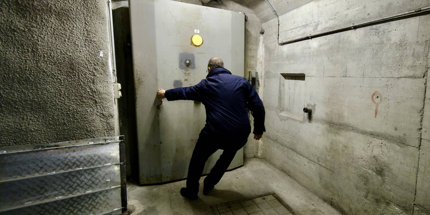 Patrick Mueller opens a bunker door of the Deltalis Swiss Mountain Data Center, a former Swiss Army bunker built in the Alps during the Cold War, on November 18, 2013, near Attinghausen, Central Switzerland.