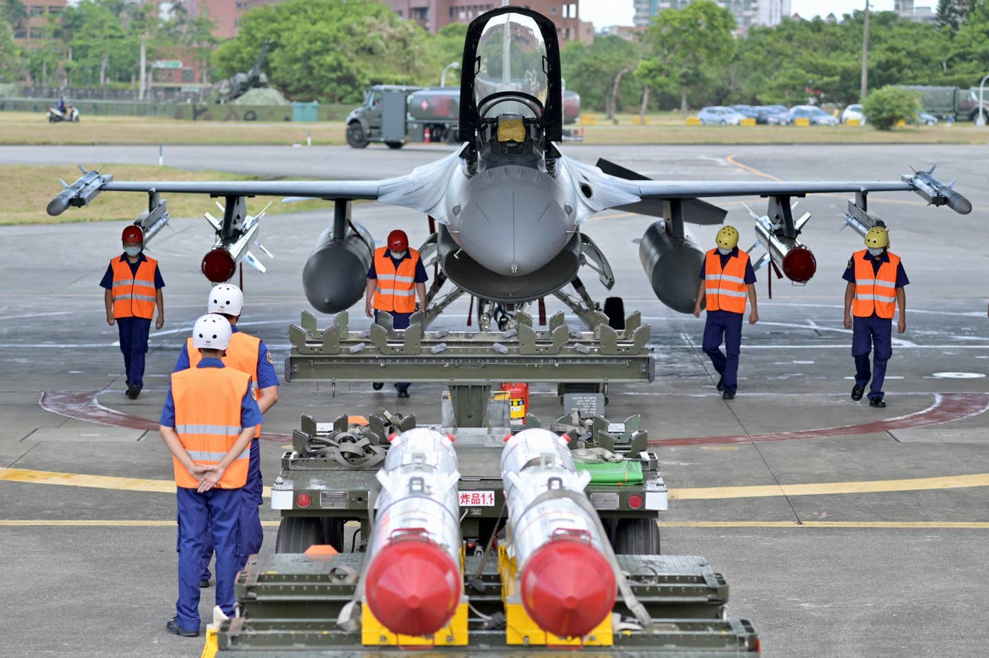 ROCAF soldiers clear the ground in front of a Harpoon-armed F-16V fighter during a drill at Hualien Air Base on August 17, 2022. <em>Photo by SAM YEH/AFP via Getty Images</em>
