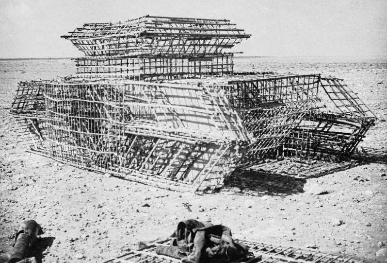 Photograph of the framework of a dummy tank under construction at the Middle East School of Camouflage in the Western Desert, 1942. <em>Cpt. Gerald Leet, British Army</em>